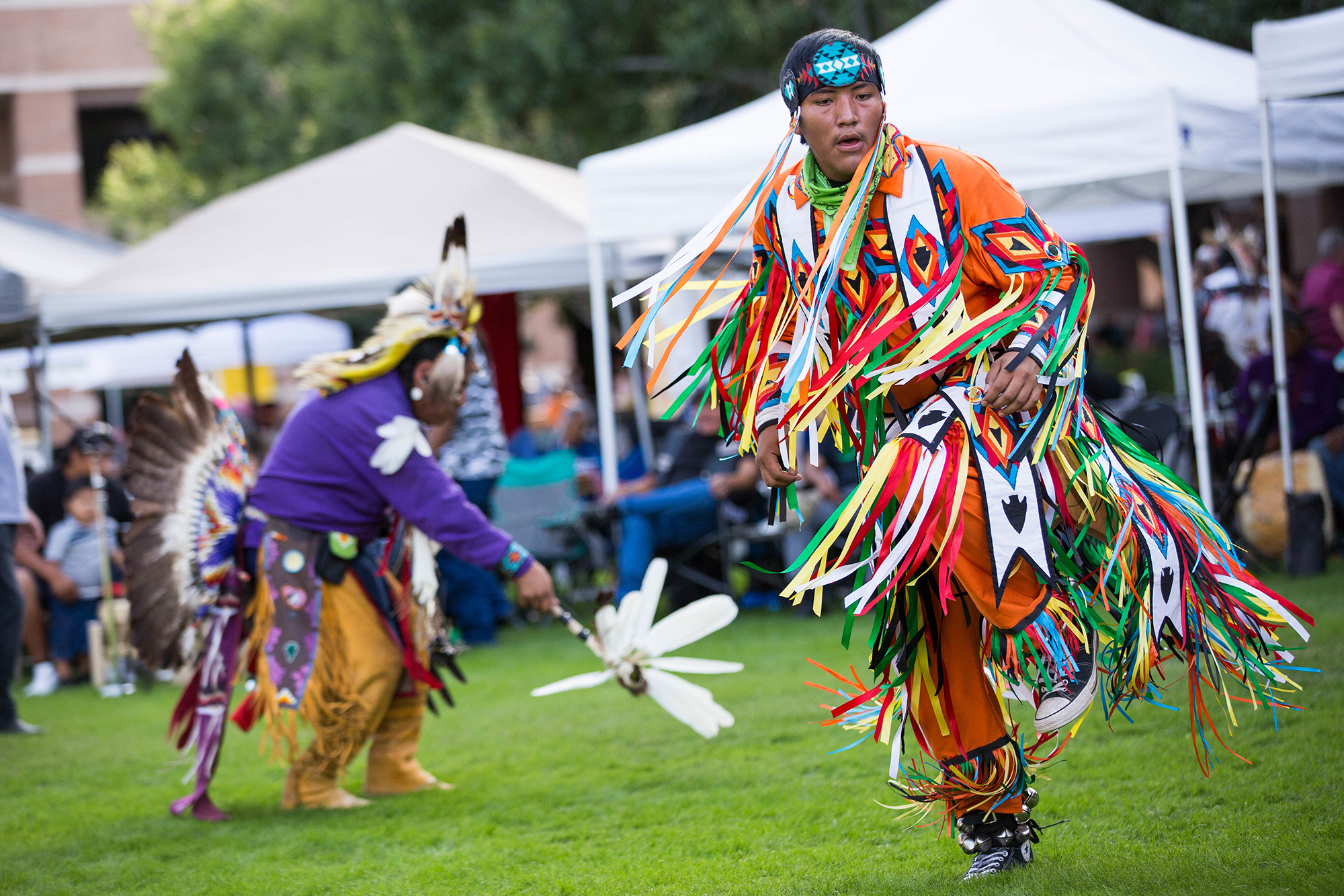man in dancing in traditional Native American dress