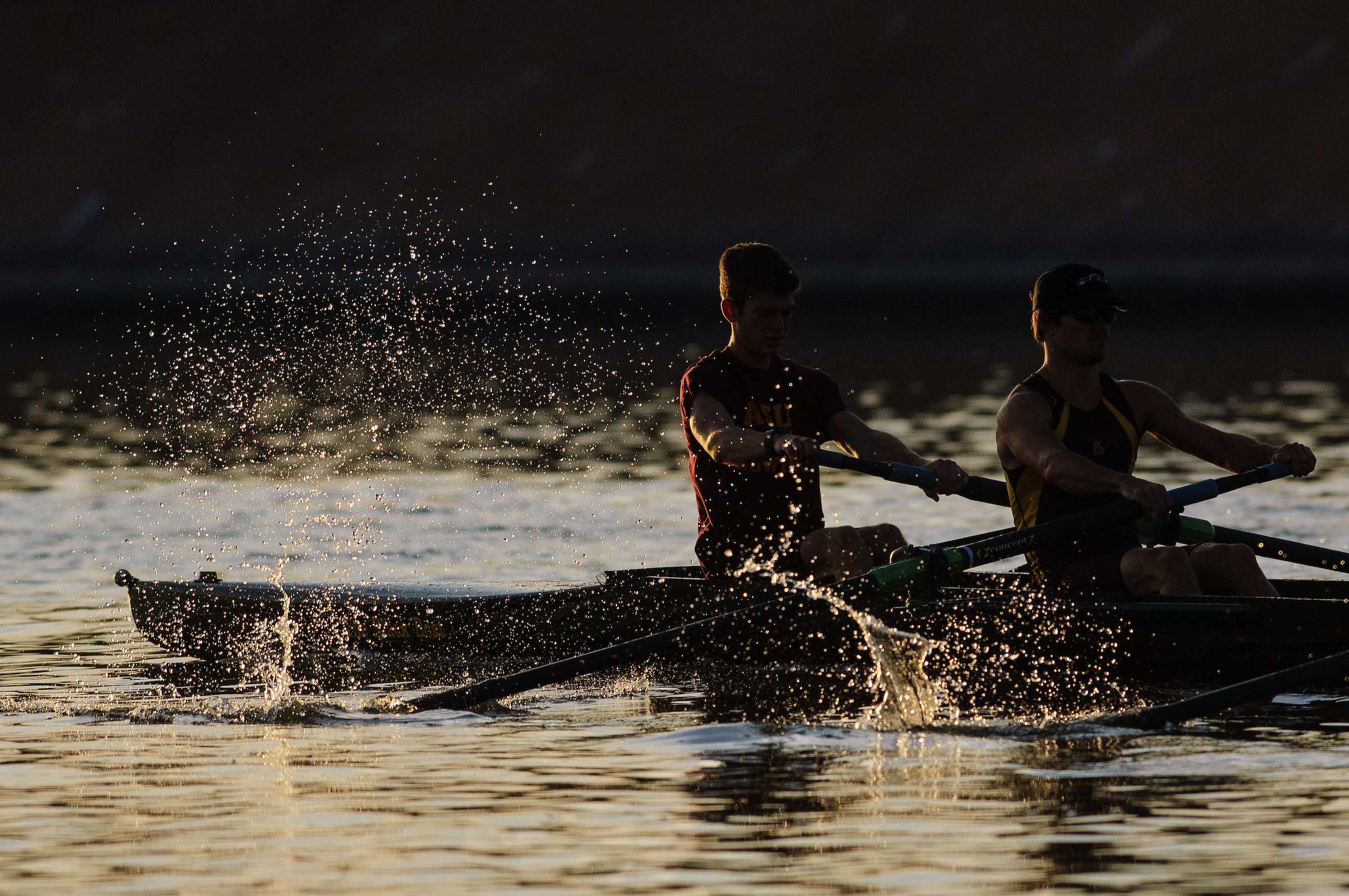two people rowing on lake