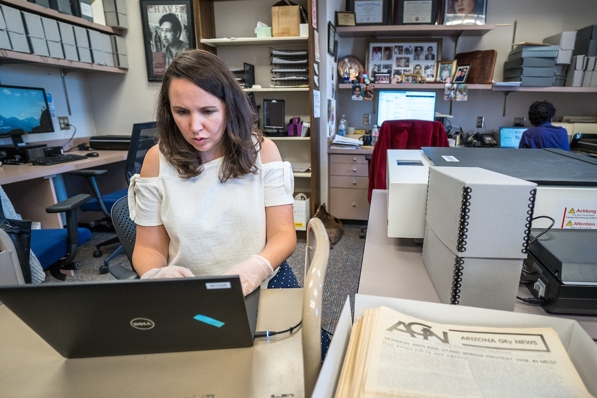 Archivist scans historical documents and photographs