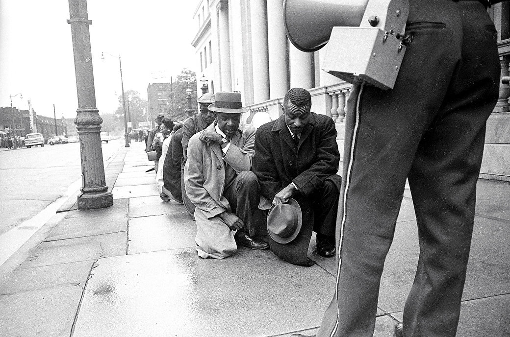 Rev. Charles Billups kneels in prayer along side Rev. Fred Shuttlesworth as their march in April of 1963 is stopped in front of the Federal Courthouse in Birmingham, AL (The Birmingham News file photo)