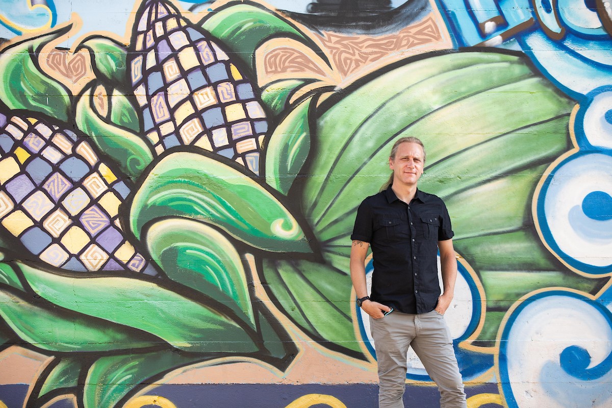 Image of Tyler Peterson in front of a mural in downtown Phoenix / Photo by Deanna Dent-ASU Now