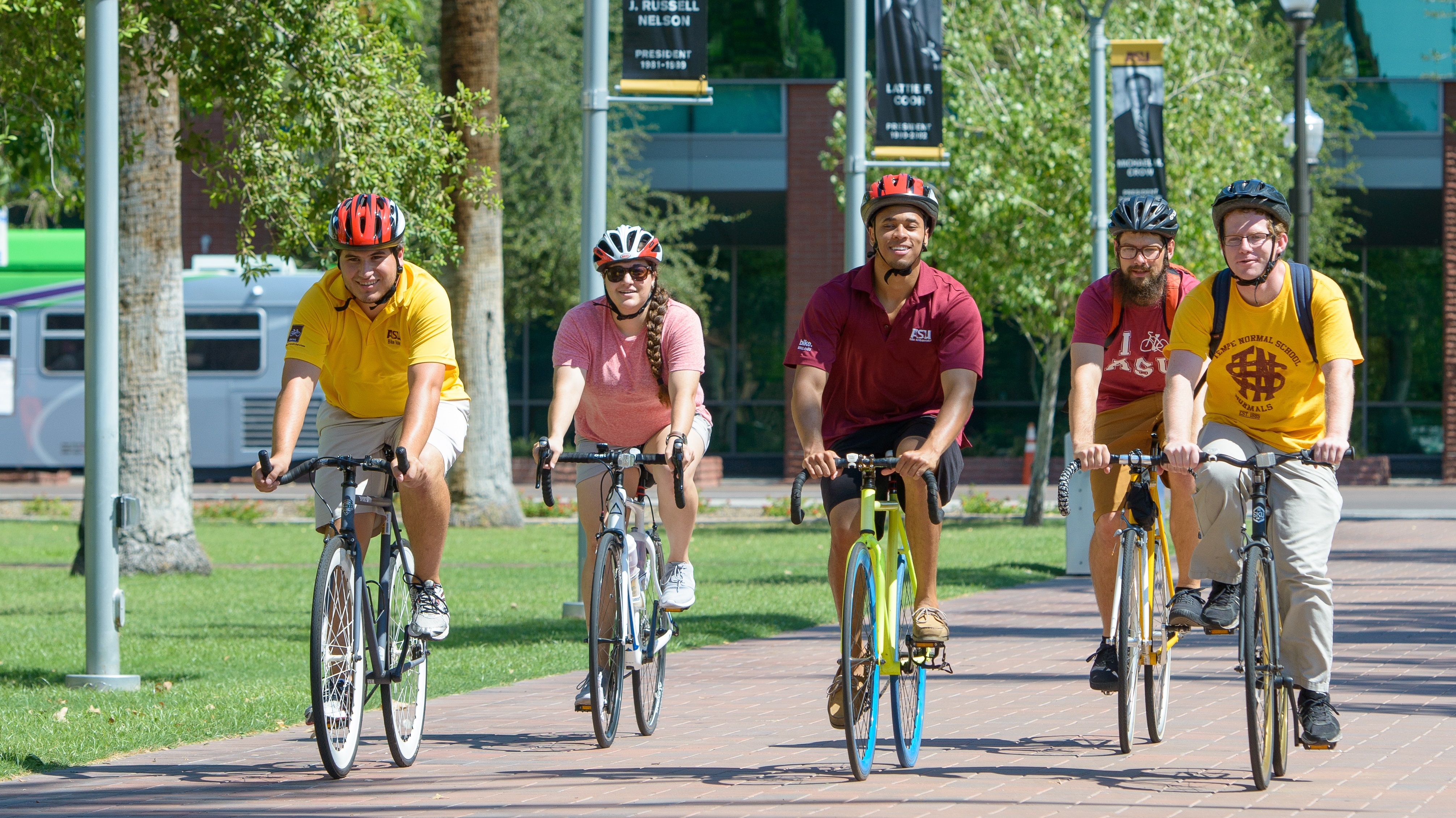 Cyclists ride their bicycles on ASU Tempe campus