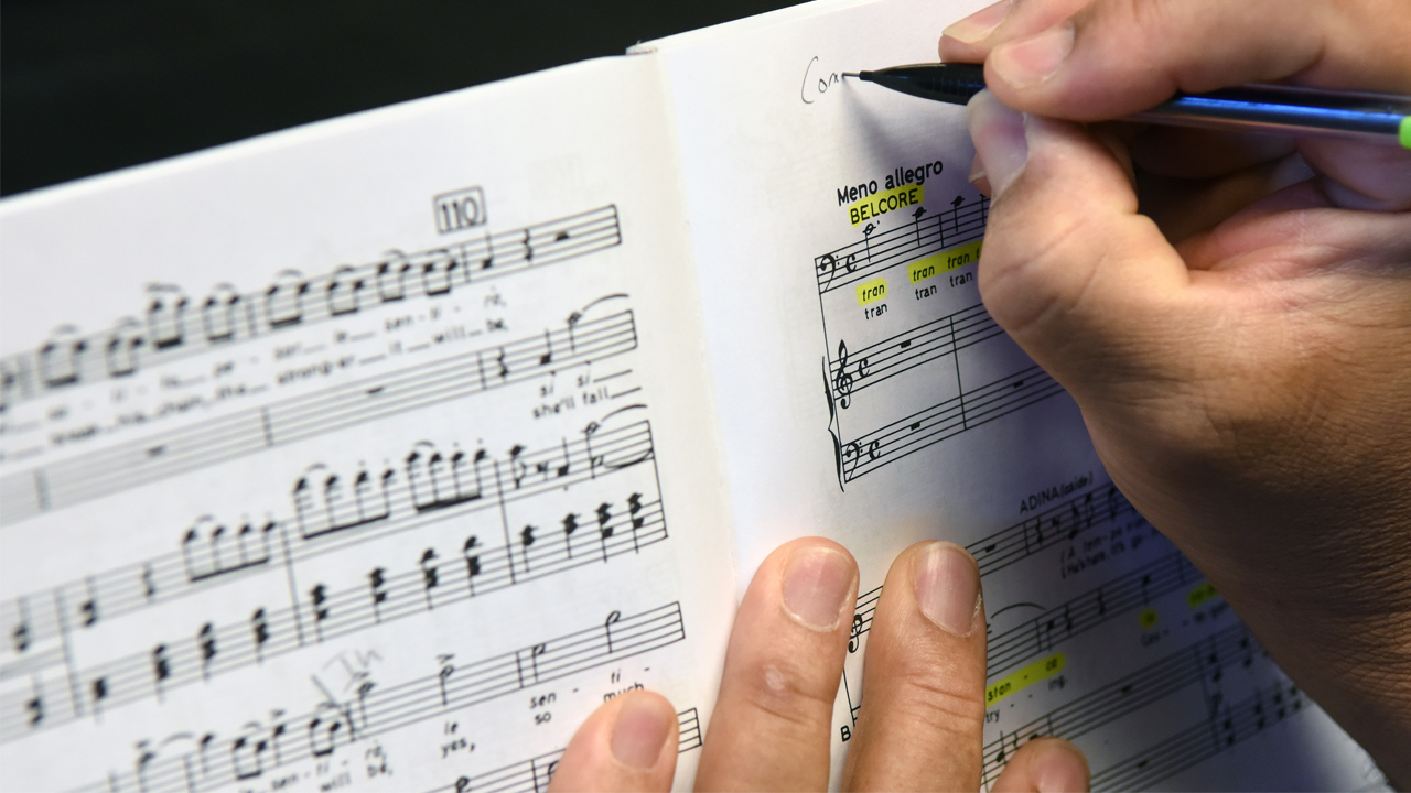 photo of a composer annotating music