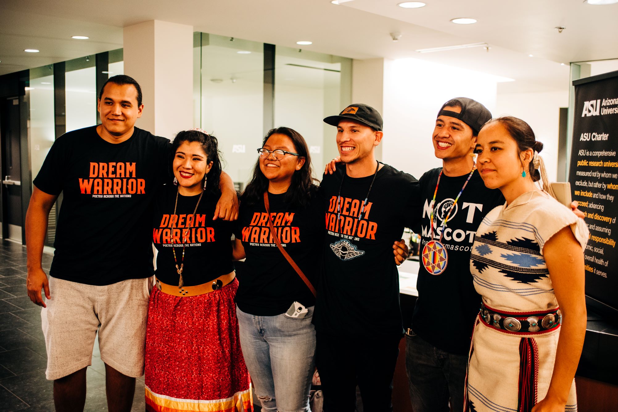 Indigenous students standing in community, celebrating.  