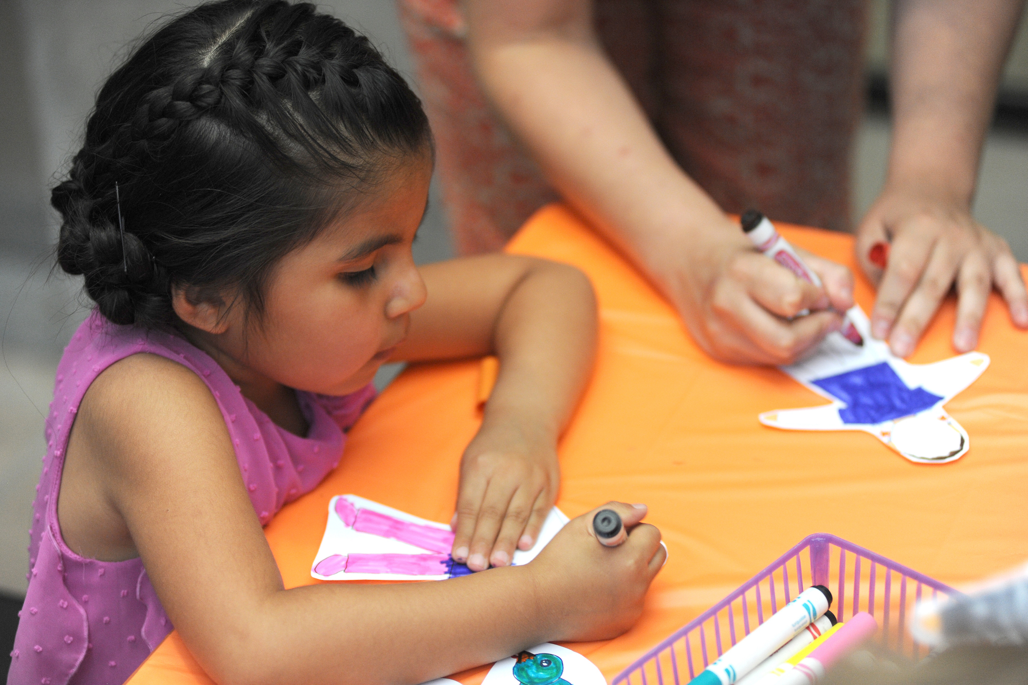 A young girl works on an art project at First Saturday for Families at the ASU Art Museum