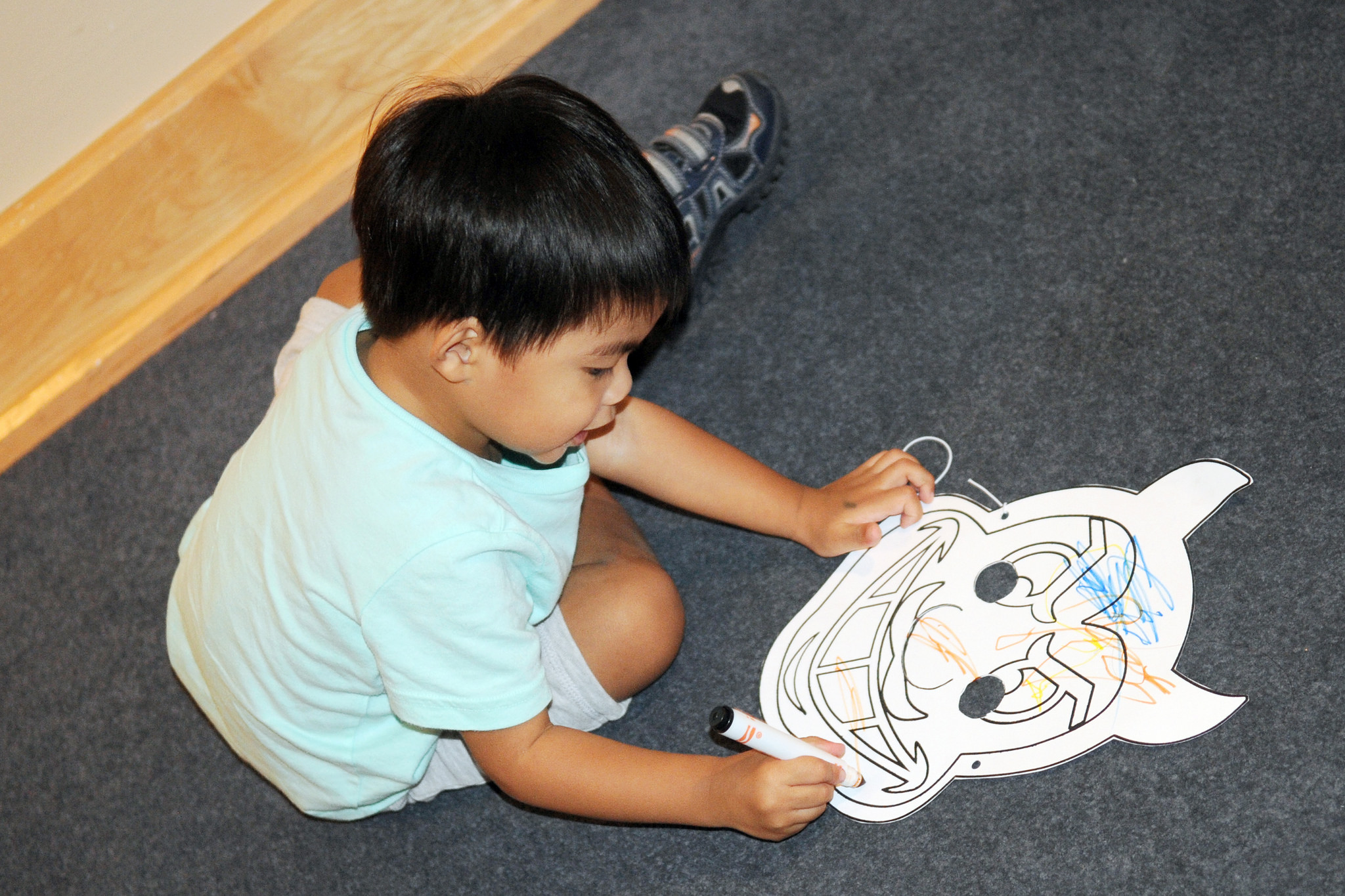 Boy draws on a sun devil mask at ASU Art Museum First Saturday for Families