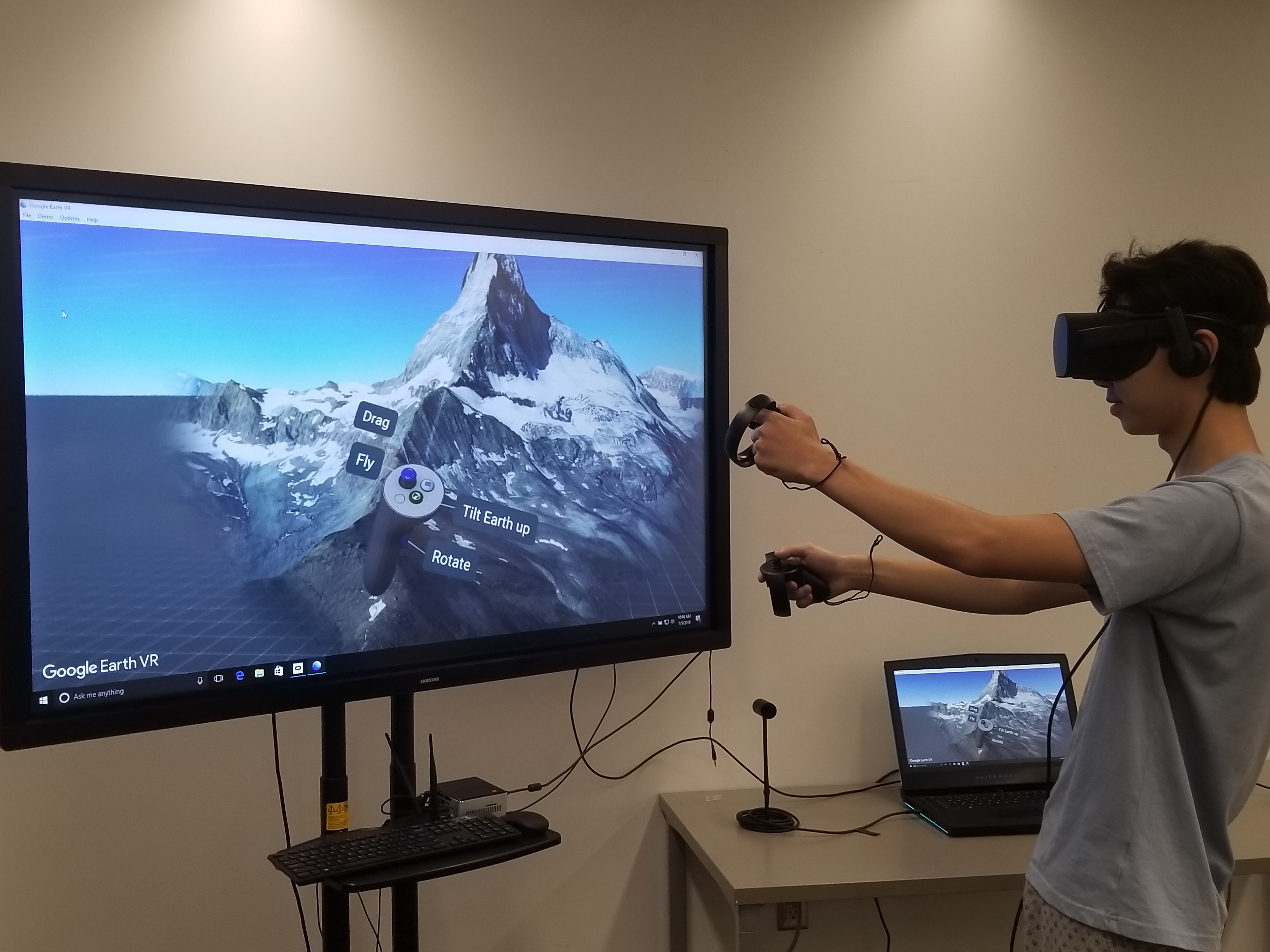 Student using Oculus Rift headset to explore Google Earth VR