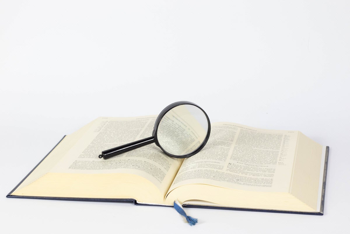 Magnifying glass on a book / Image by Marco Verch on Flickr