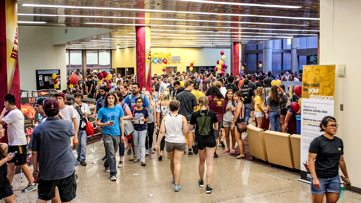 Picture of a large groups of students walking through the Sun Devil Fitness Complex lobby