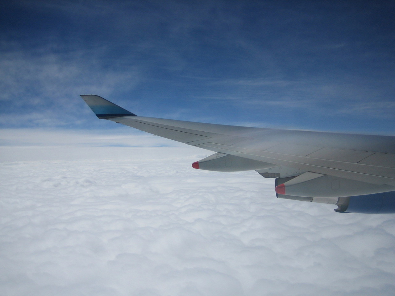 view of clouds, plane wing from plane windo