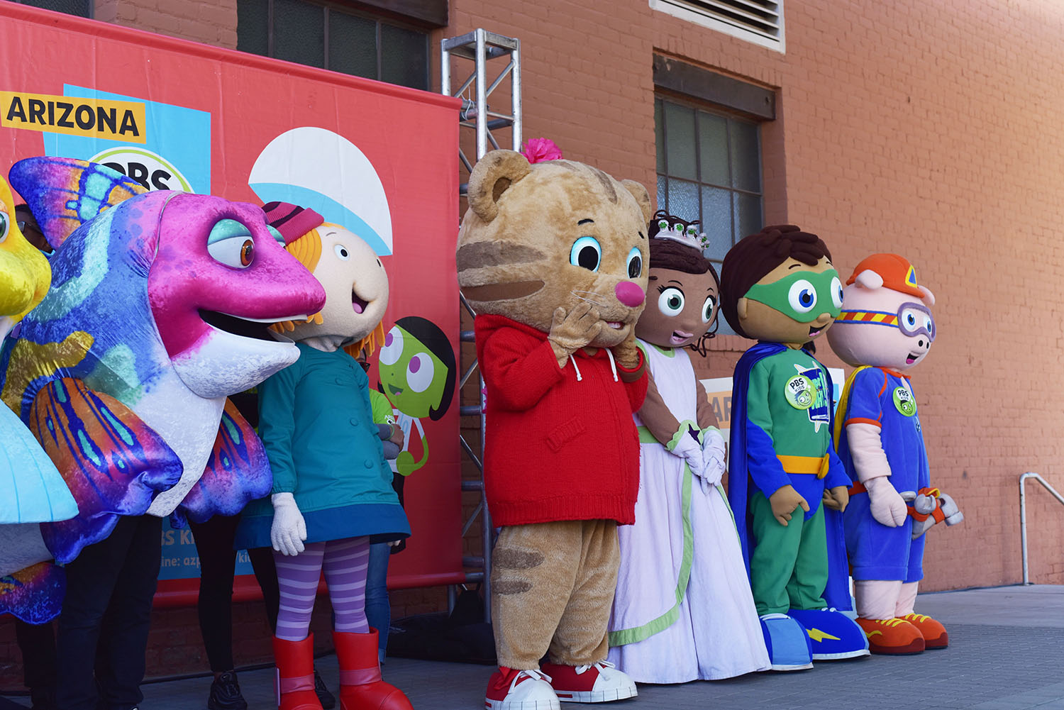 Mascots stand onstage during Arizona PBS KIDS Day 2019.