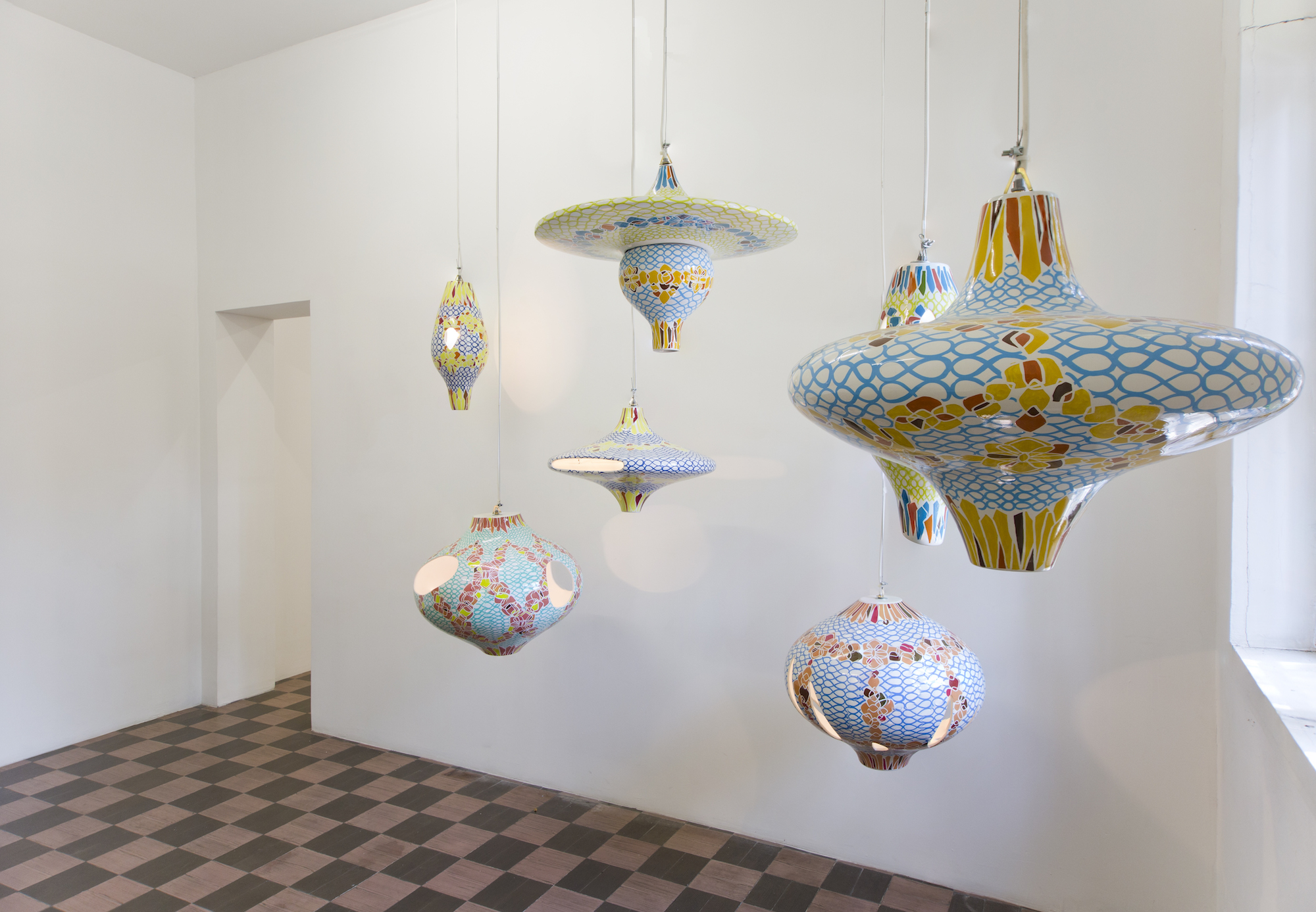 Seven hand-painted ceramic light fixtures, dimensions variable are part of this artwork by Jorge Pardo