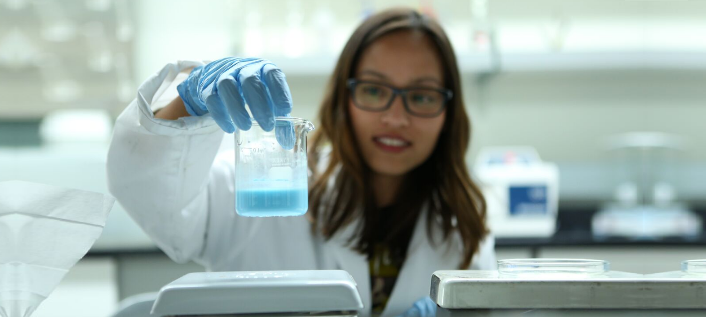 woman holding beaker in a lab
