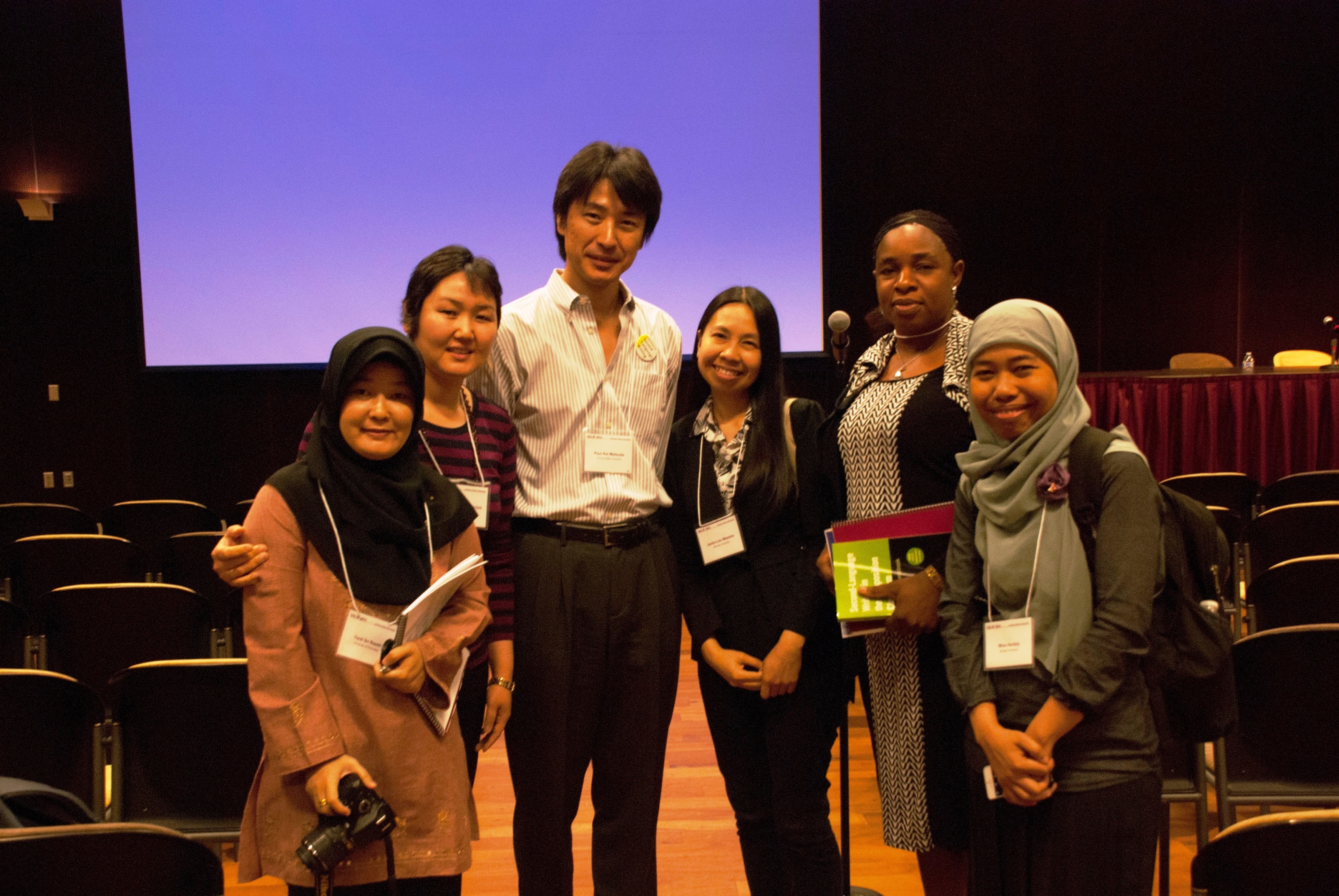 Symposium Chair Paul Kei Matsuda (center) with 2014 participants.