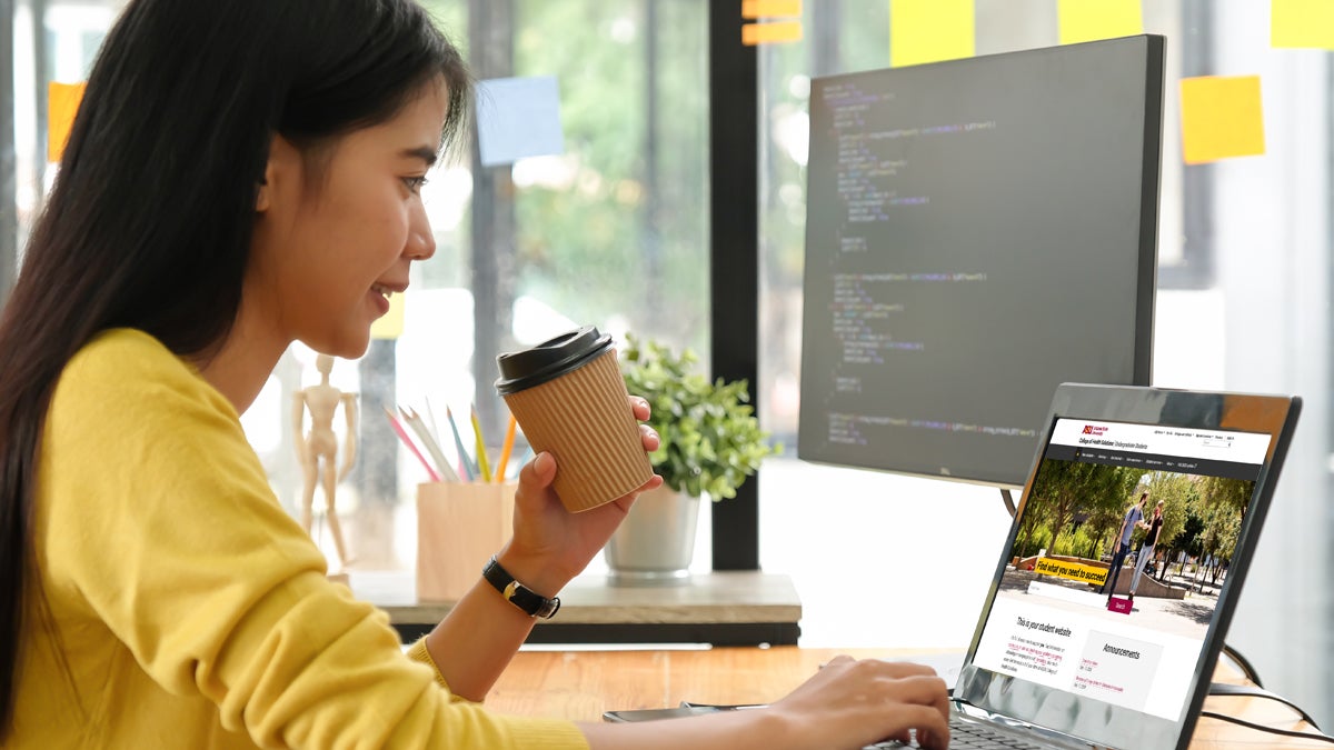 young professional woman uses laptop for work