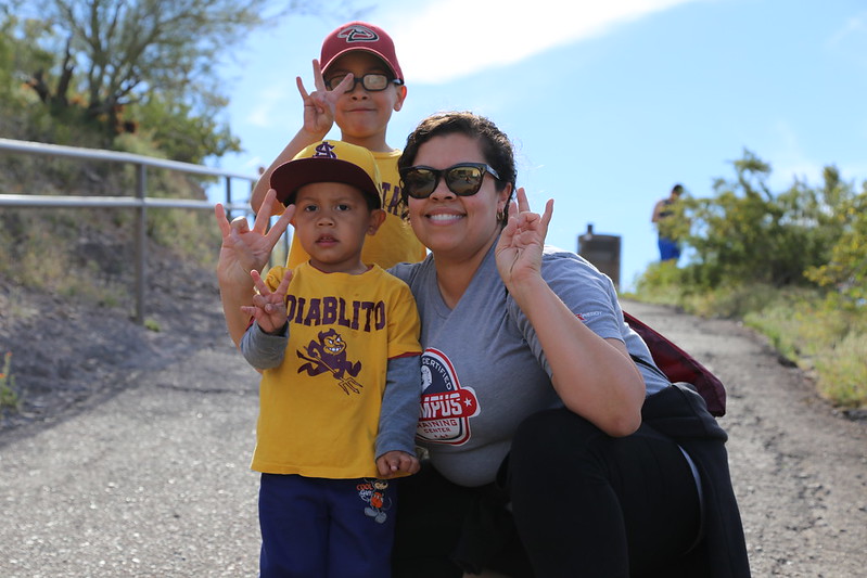 A family of Sun Devils smiles while hiking 'A' Mountain.