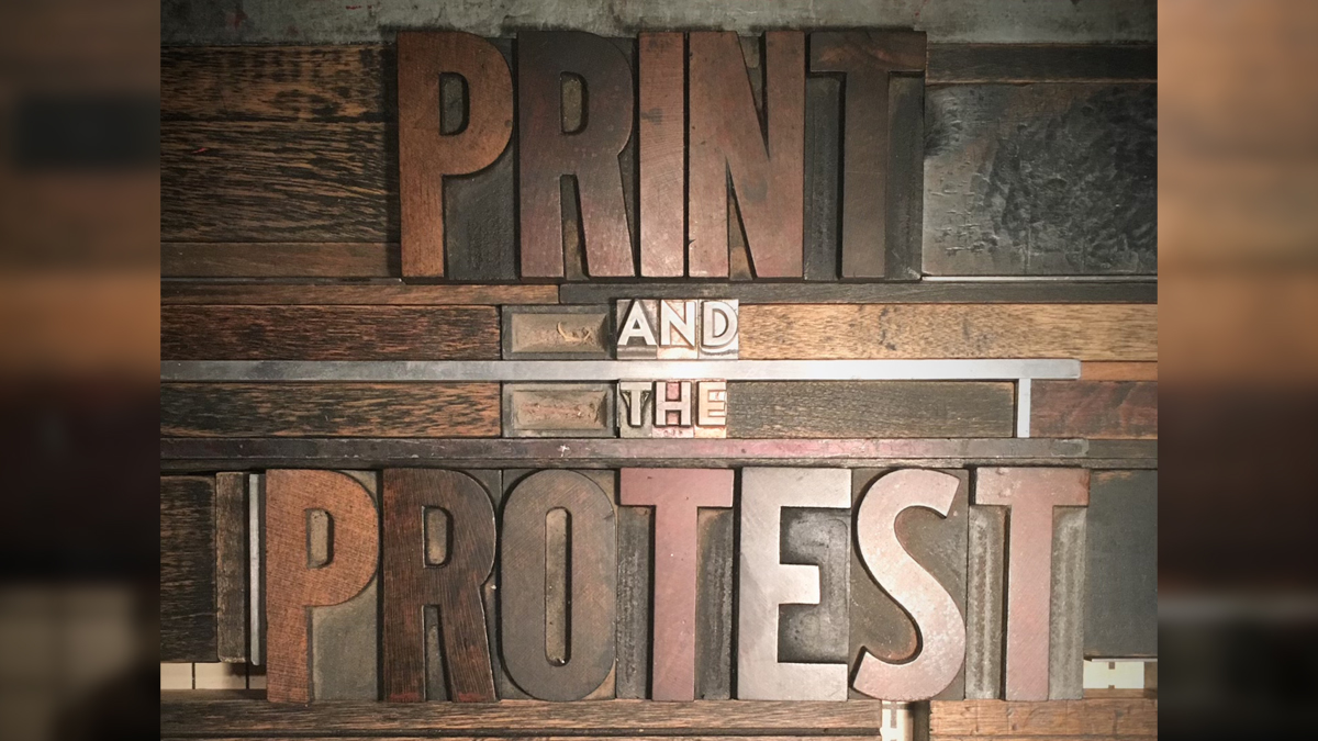 Letterpress block letters in metal and wood spelling out Print and the Protest