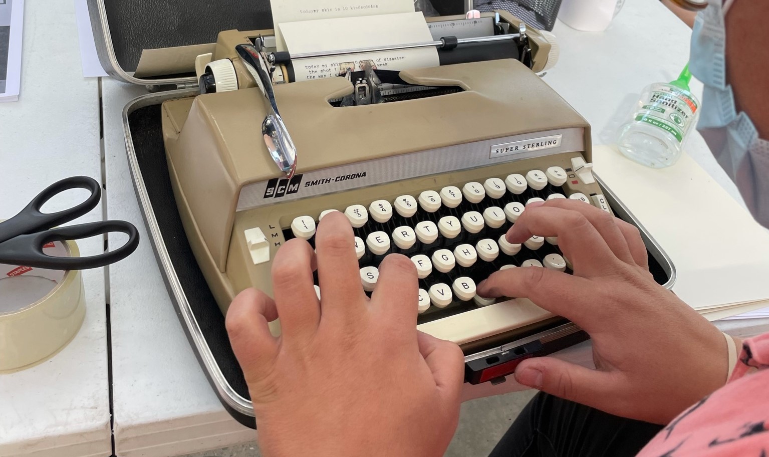 A person types on a manual typewriter / Photo by Sally Ball