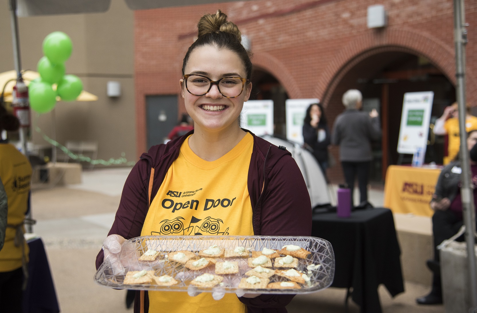 A Health Solutions volunteer offers nutritious treats during ASU's Open Door event.