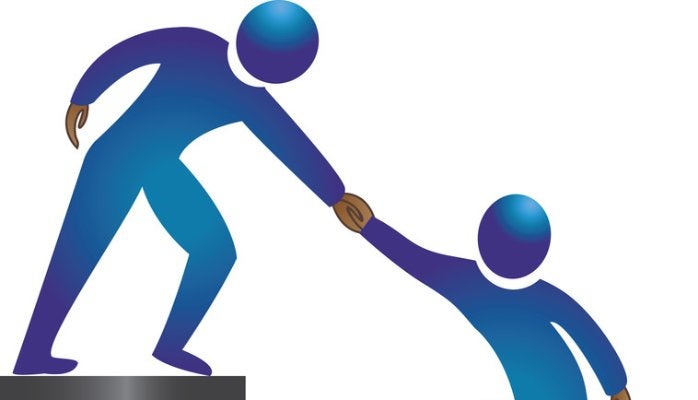 A person helps another person up / Credit Wikimedia Commons