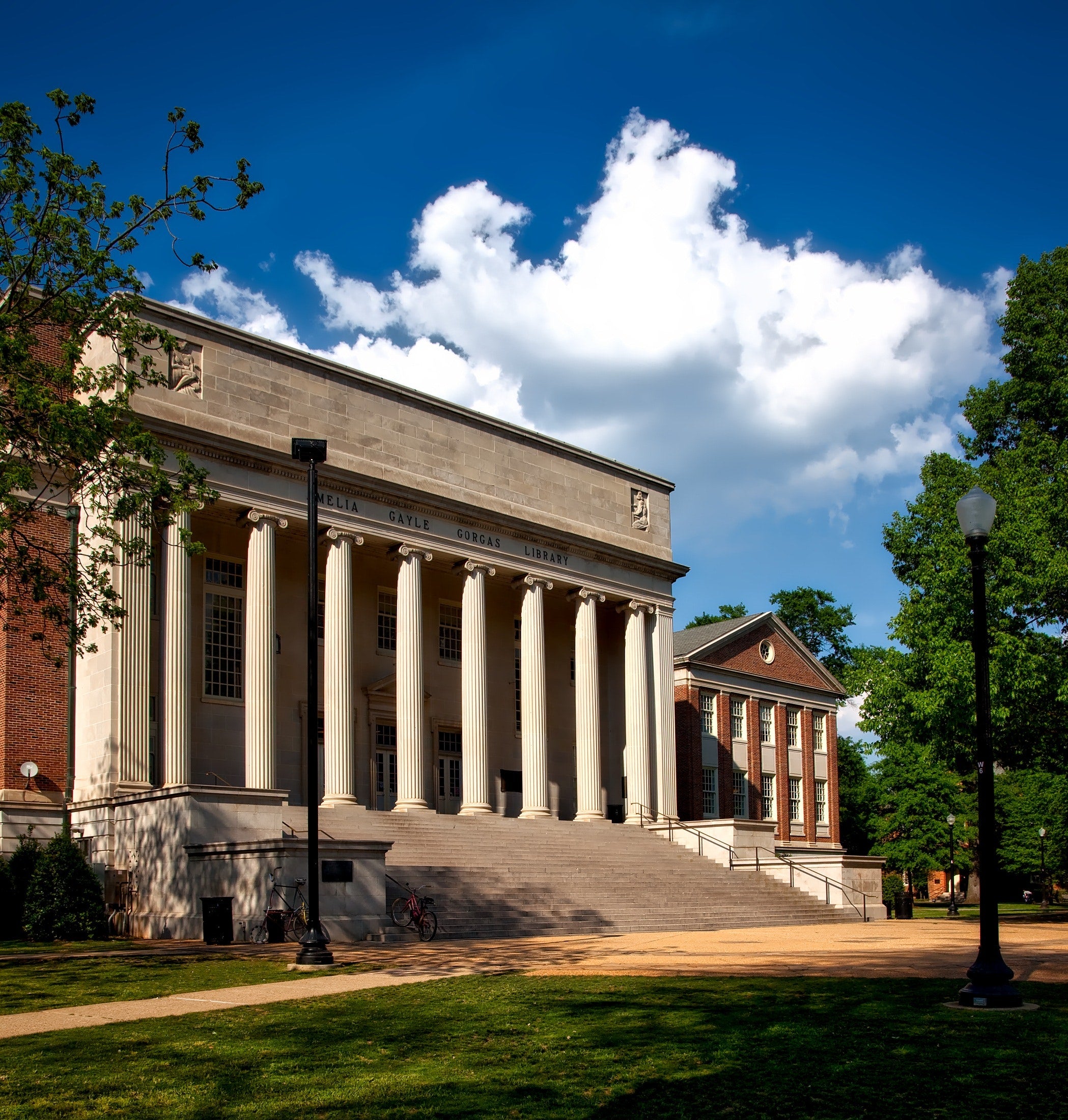 A brick building with large white columns. 