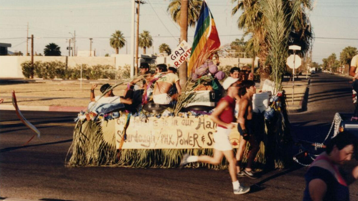 People participating in a parade, either walking or sitting in a float