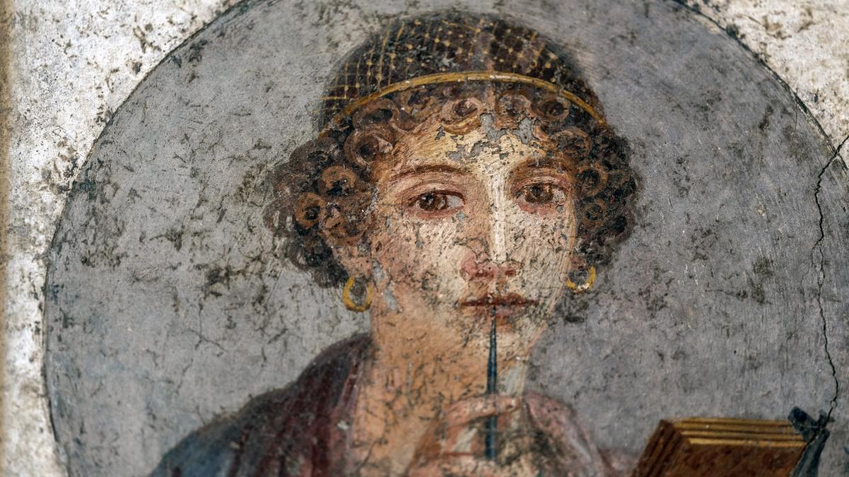 A young woman holding a stylus and wax tablet (known as Sappho), c. 55–79 C.E., found Insula Occidentalis, Pompeii (National Archeological Museum, Naples) / Credit Steven Zucker on Flickr. Used under CC 2.0.