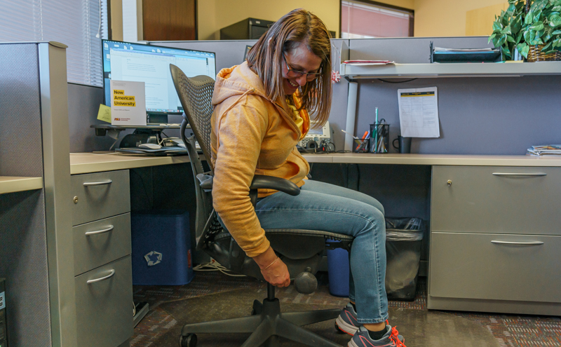 Chair Yoga by Emmanuel Padilla A woman sitting on a chair adjusting height